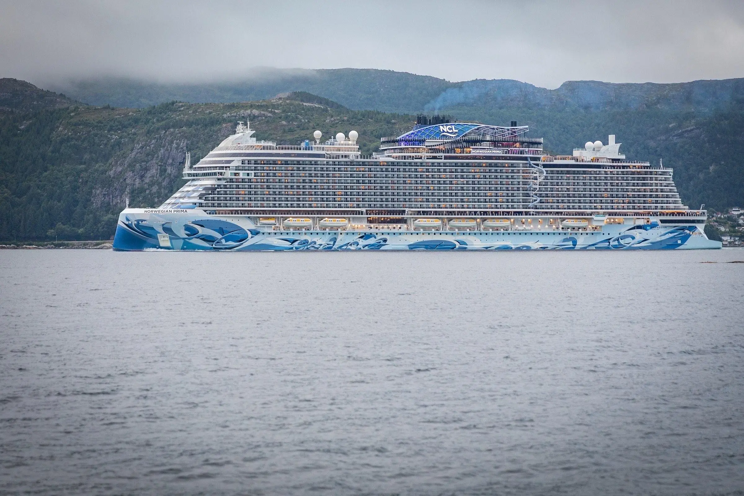 Norwegian Prima passing Husevåg in Nordfjord, Norway
